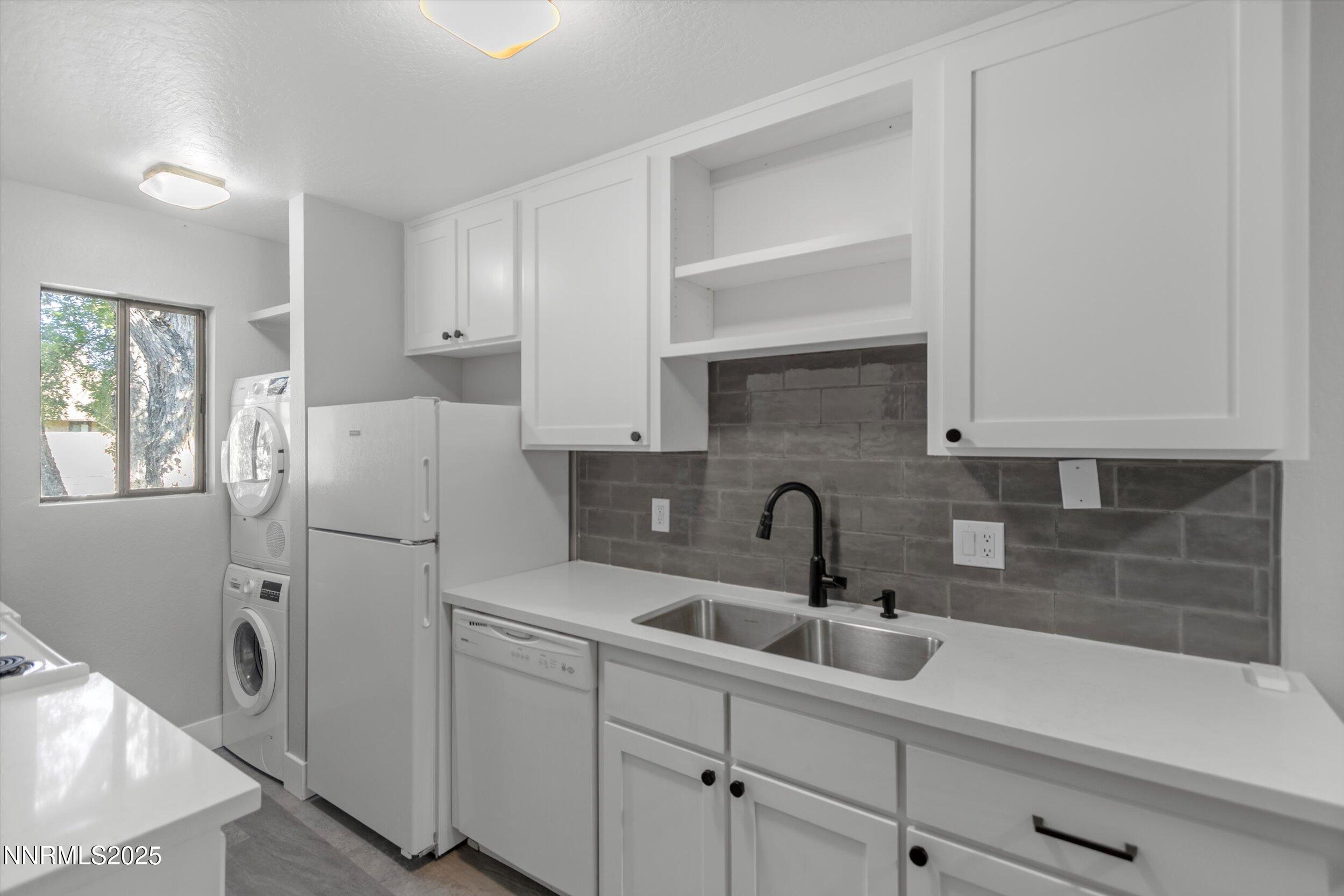 4634 Rio Poco Road Reno, NV 89502 - Photo 9 of 24 a kitchen with a refrigerator sink and cabinets