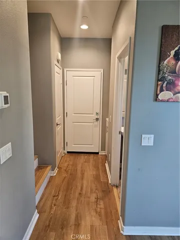 a view of a hallway with wooden floor