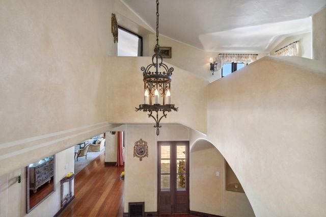 a view of a swimming pool with chairs in patio