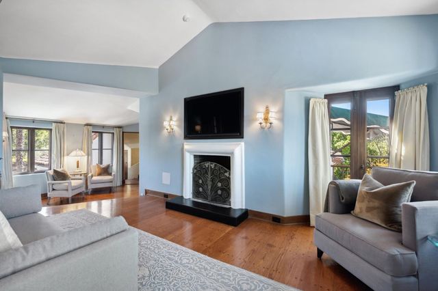a view of a patio with couches table and chairs and potted plants