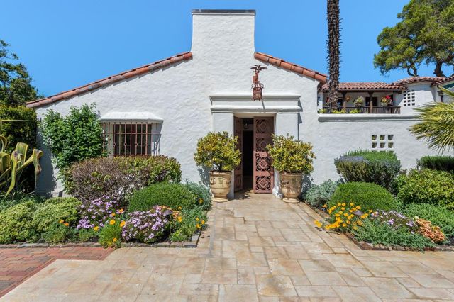 a view of a patio with table and chairs potted plants