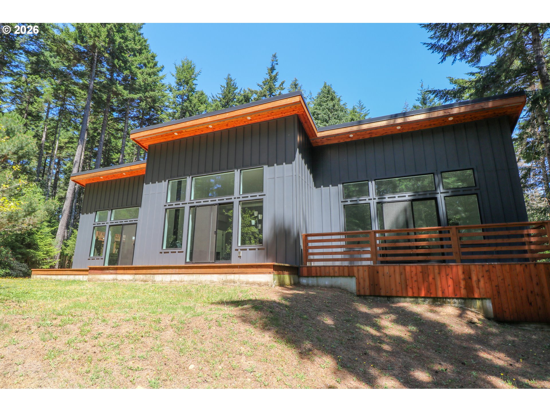 59492 Seven Devils Road Bandon, OR 97411 - Photo 1 of 48 a front view of a house with a yard