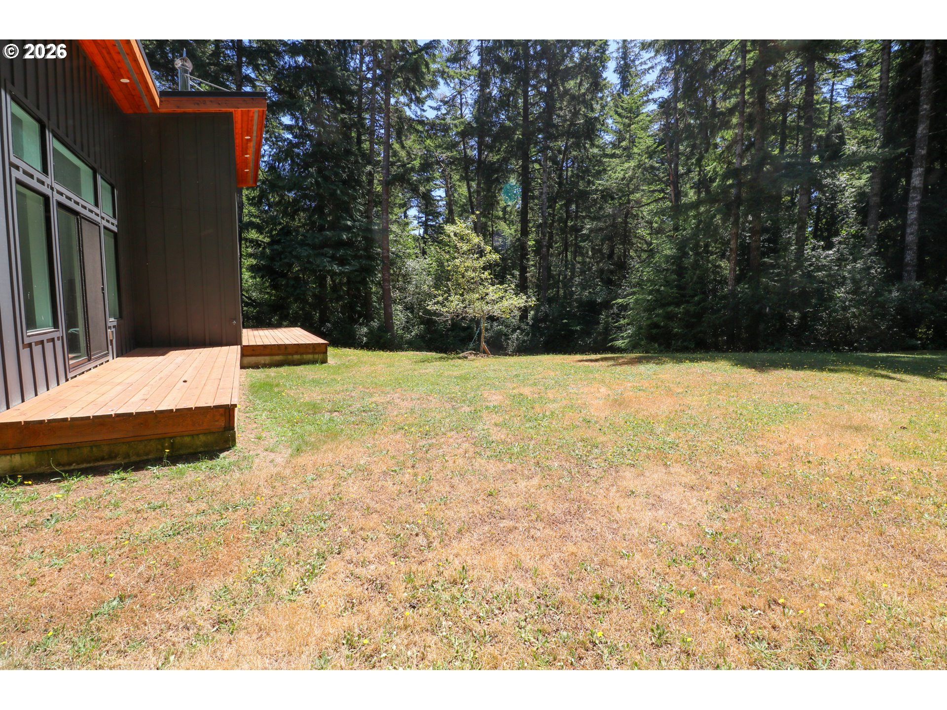 59492 Seven Devils Road Bandon, OR 97411 - Photo 15 of 48 a view of white house with a yard