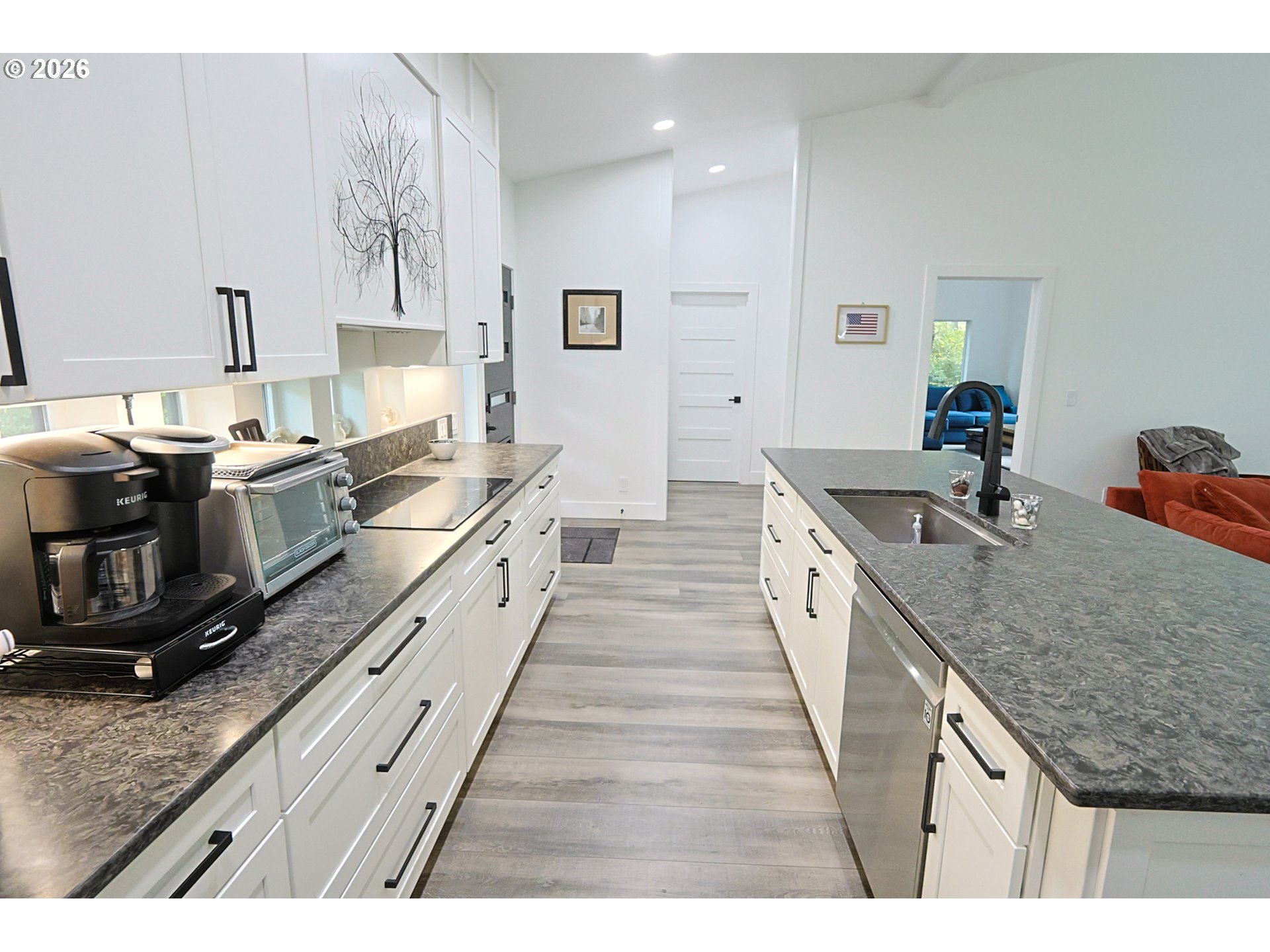 59492 Seven Devils Road Bandon, OR 97411 - Photo 27 of 48 a large kitchen with stainless steel appliances granite countertop a lot of counter space and wooden floor