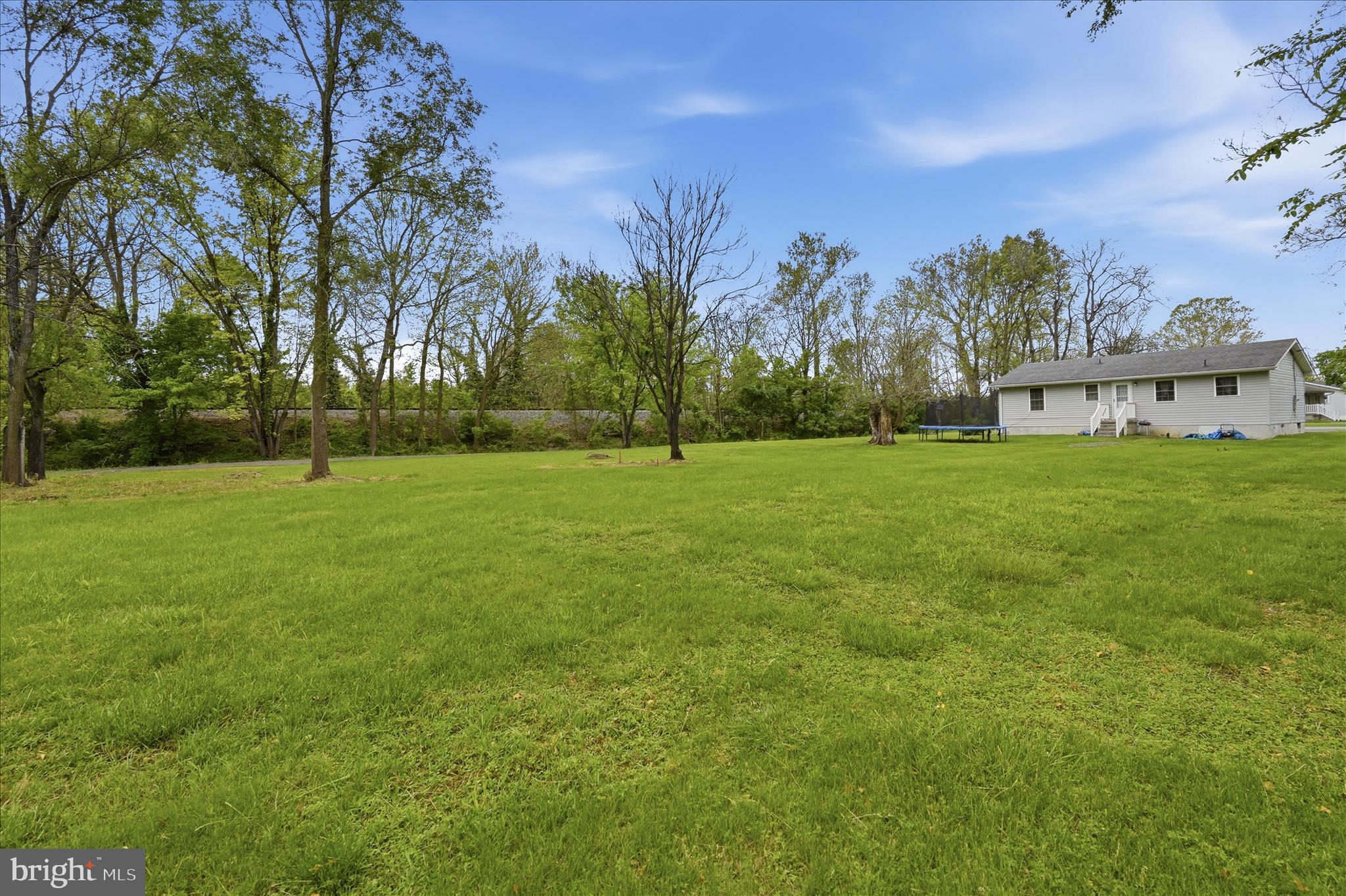 415 McDonald Street Ranson, WV 25438 - Photo 4 of 16 a view of a grassy field with trees in the background