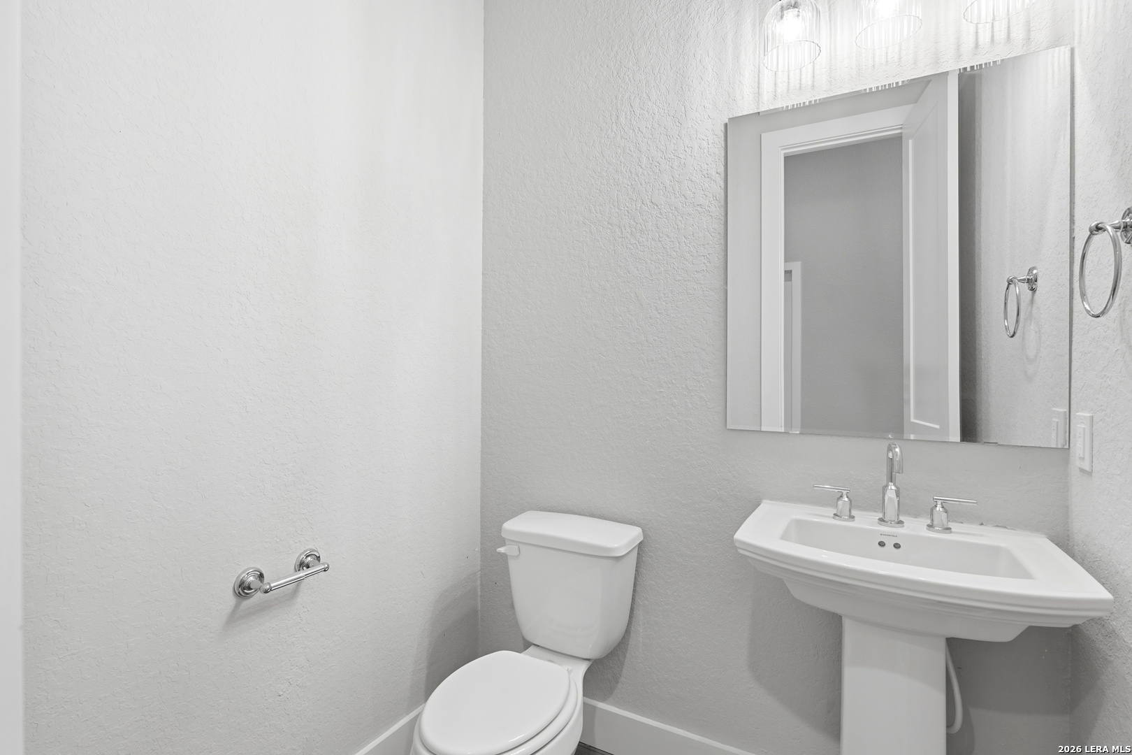 3018 Daplyn Bulverde, TX 78163 - Photo 16 of 36 a bathroom with a toilet sink and mirror