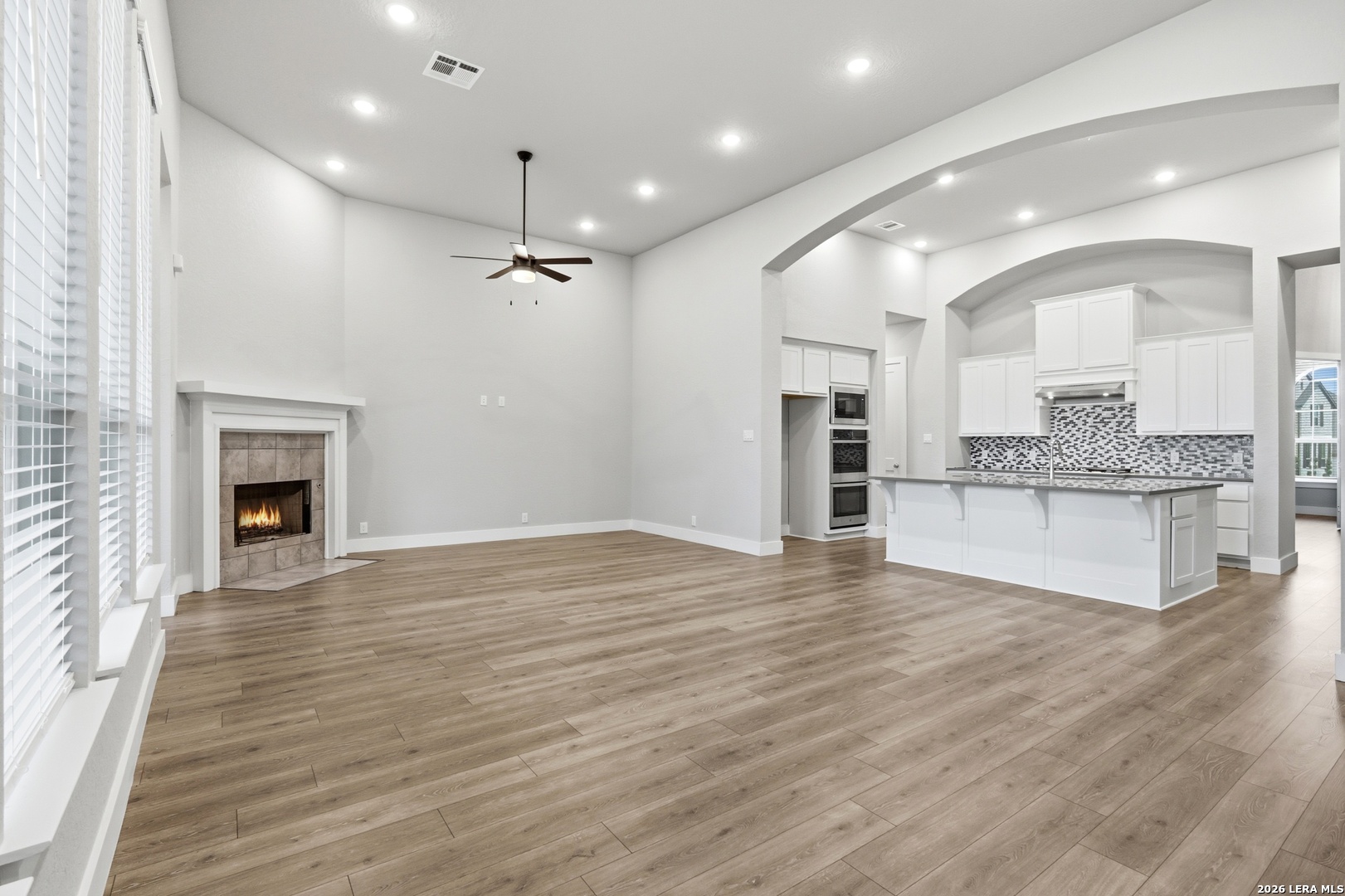 3018 Daplyn Bulverde, TX 78163 - Photo 9 of 36 a view of an empty room with a fireplace and kitchen view
