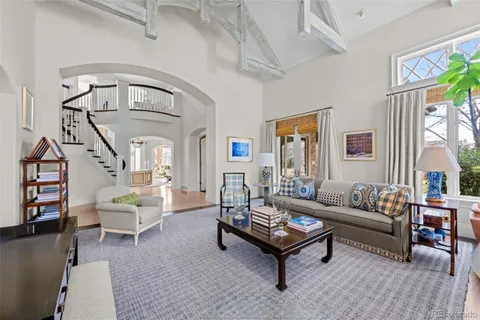 a living room with furniture and a book shelf