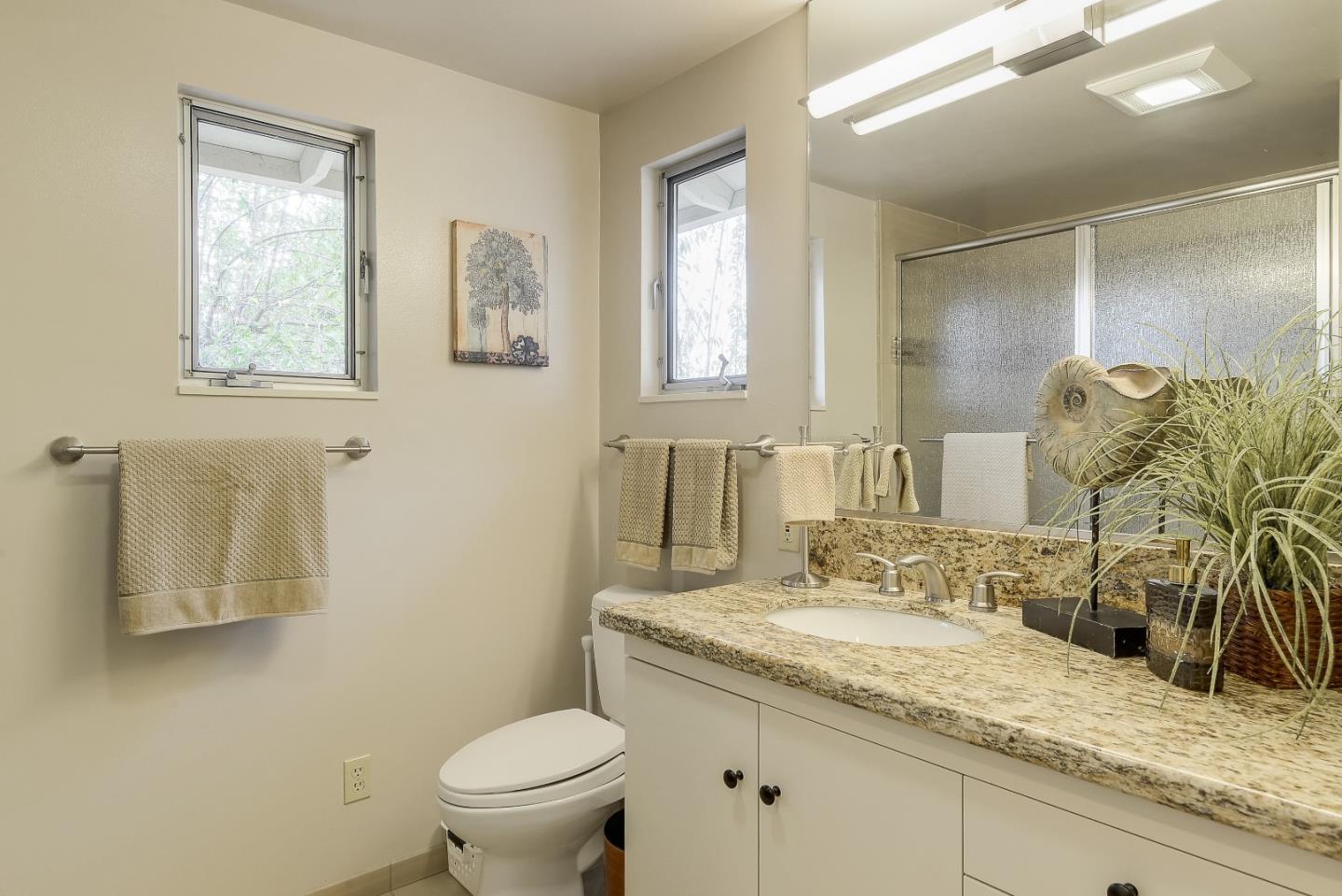 20143 Beatty Ridge Road Los Gatos, CA 95033 - Photo 12 of 21 a bathroom with a granite countertop sink a toilet and a mirror
