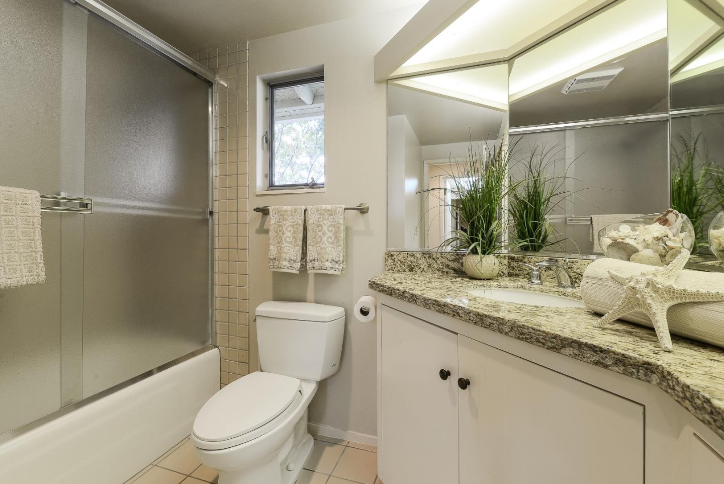 20143 Beatty Ridge Road Los Gatos, CA 95033 - Photo 16 of 21 a bathroom with a granite countertop sink toilet and shower