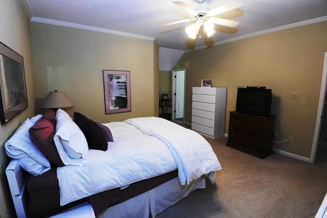 a living room with furniture a flat screen tv and a dining table