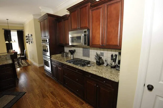 a view of a dining room with furniture a chandelier and wooden floor