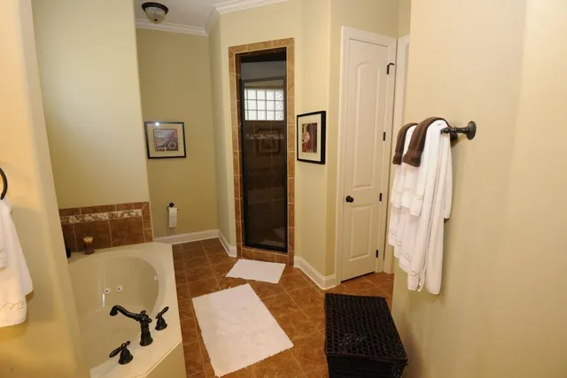 a bathroom with a granite countertop sink a toilet and mirror