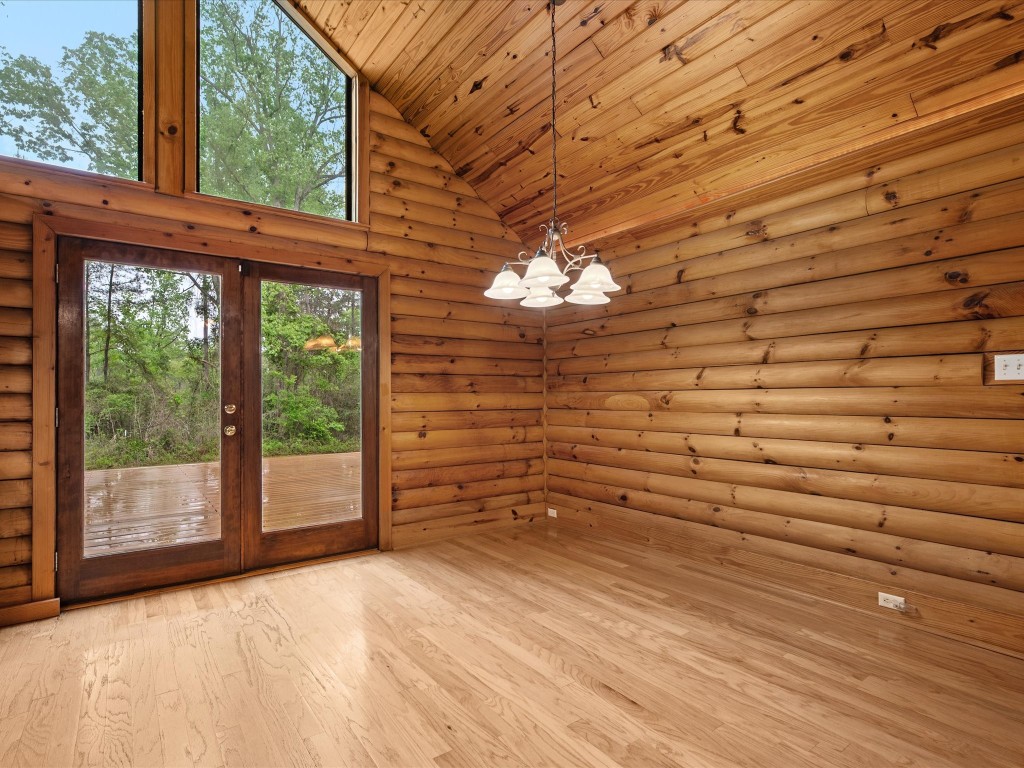 12868 Levi Road Willis, TX 77378 - Photo 14 of 41 Cozy dining area with warm wood finishes and direct access to the outdoor deck—perfect for indoor-outdoor entertaining.