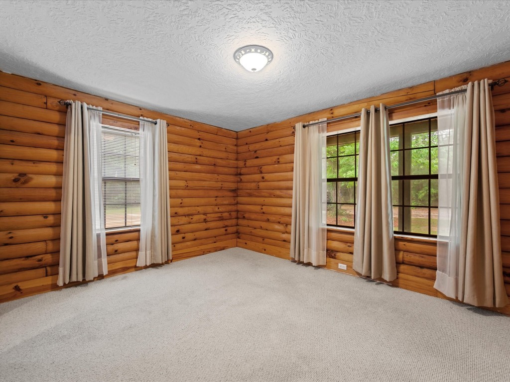 12868 Levi Road Willis, TX 77378 - Photo 18 of 41 Spacious secondary bedroom with warm wood accents, soft natural light, and a peaceful, cozy atmosphere.