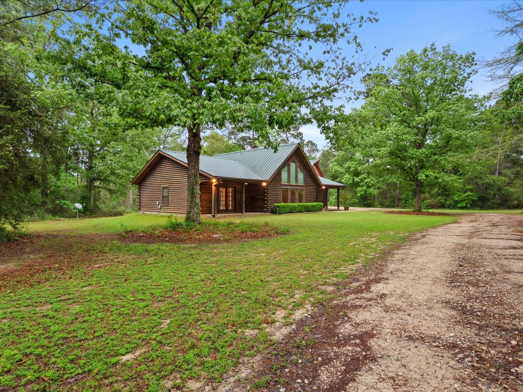 12868 Levi Road Willis, TX 77378 - Photo 30 of 41 Beautifully maintained log home offering timeless charm, privacy, and serene natural surroundings.