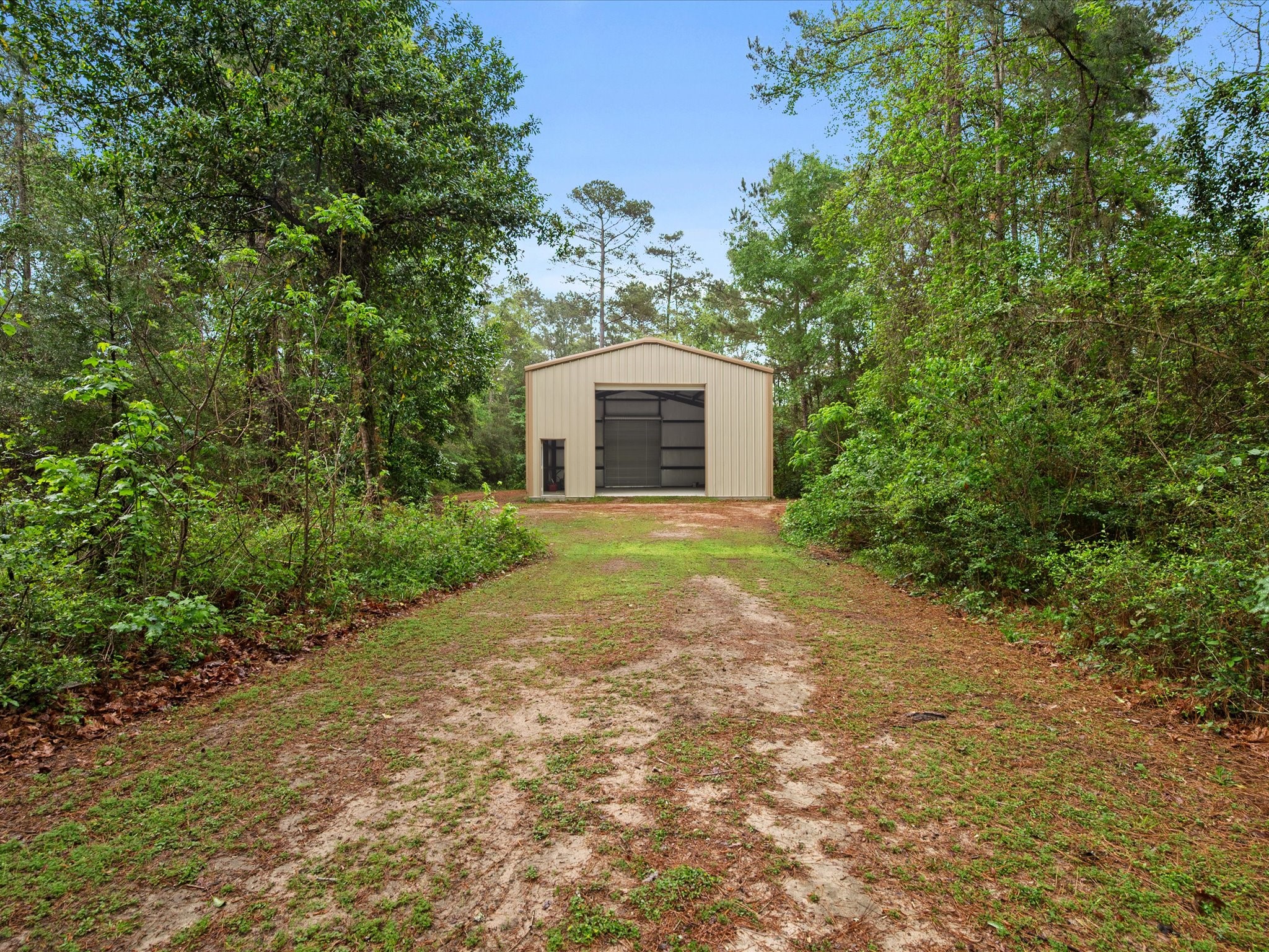 12868 Levi Road Willis, TX 77378 - Photo 32 of 41 Impressive 30x50 fully insulated shop—perfect for storage, hobbies, or workspace needs.