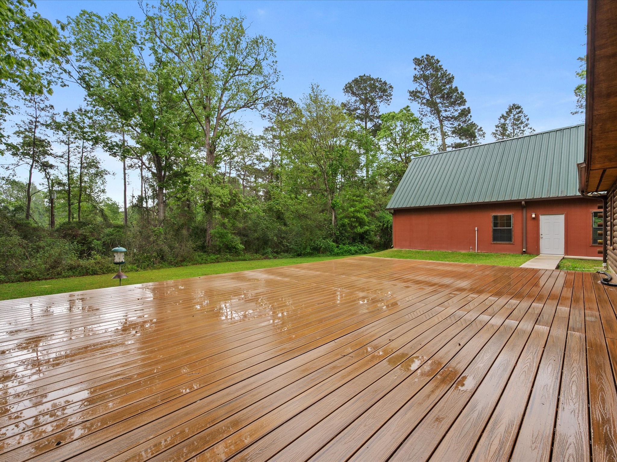 12868 Levi Road Willis, TX 77378 - Photo 33 of 41 Expansive outdoor deck overlooking peaceful wooded surroundings—perfect for relaxing or entertaining.