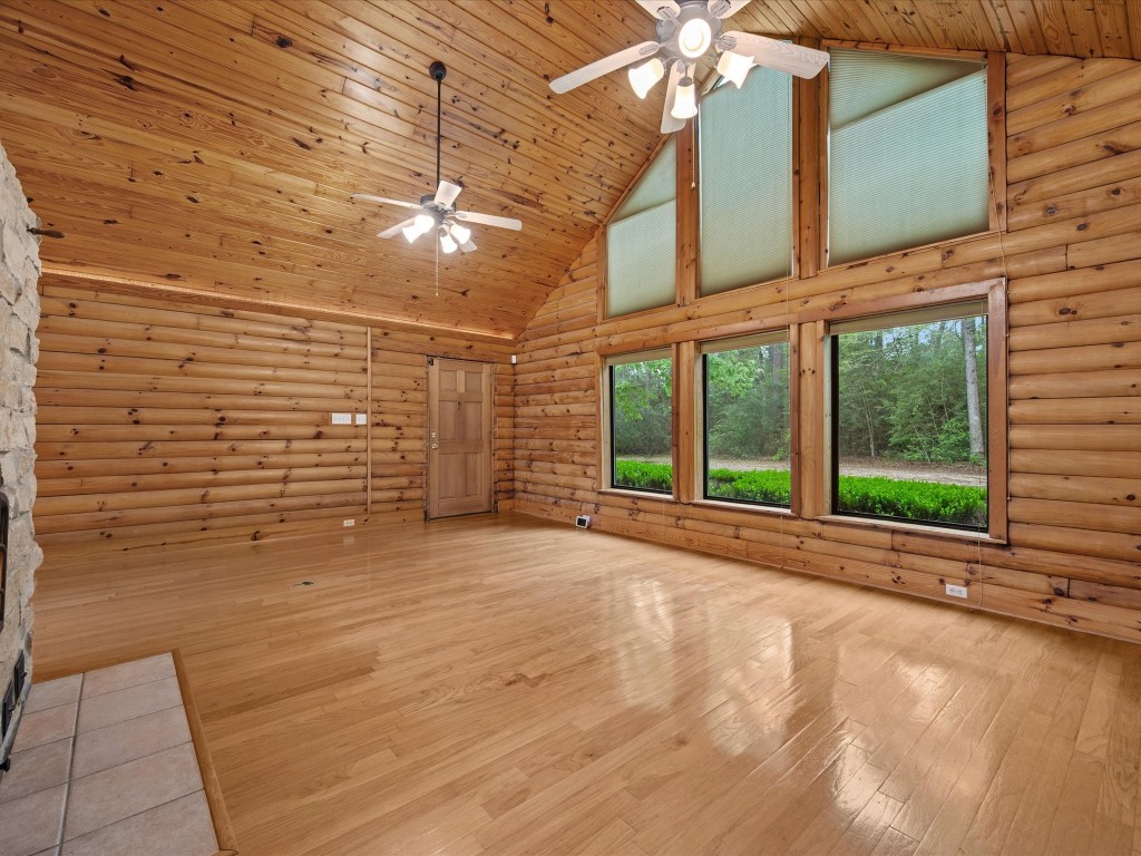 12868 Levi Road Willis, TX 77378 - Photo 9 of 41 Bright, open living space with soaring ceilings, warm wood finishes, and large windows bringing the outdoors in.