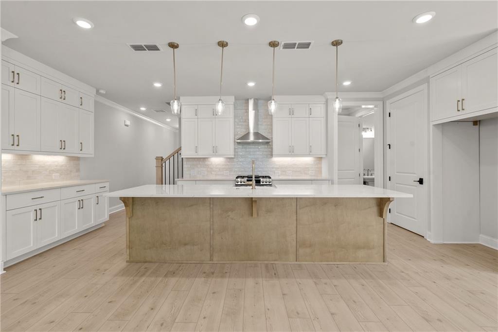 5715 Broad River View, Unit 449 Peachtree Corners, GA 30092 - Photo 11 of 29 a large kitchen with kitchen island a island a sink stainless steel appliances and cabinets