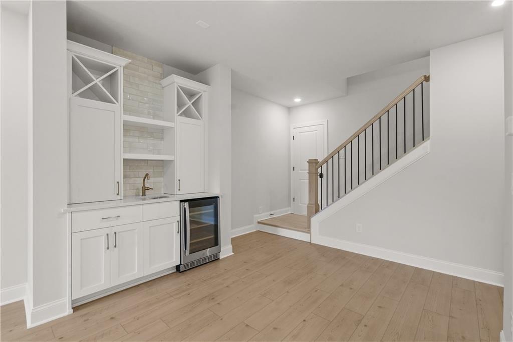 5715 Broad River View, Unit 449 Peachtree Corners, GA 30092 - Photo 16 of 29 a hallway with cabinets and wooden floor