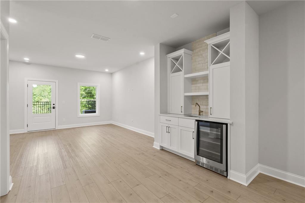 5715 Broad River View, Unit 449 Peachtree Corners, GA 30092 - Photo 18 of 29 a view of a kitchen with wooden floor and electronic appliances