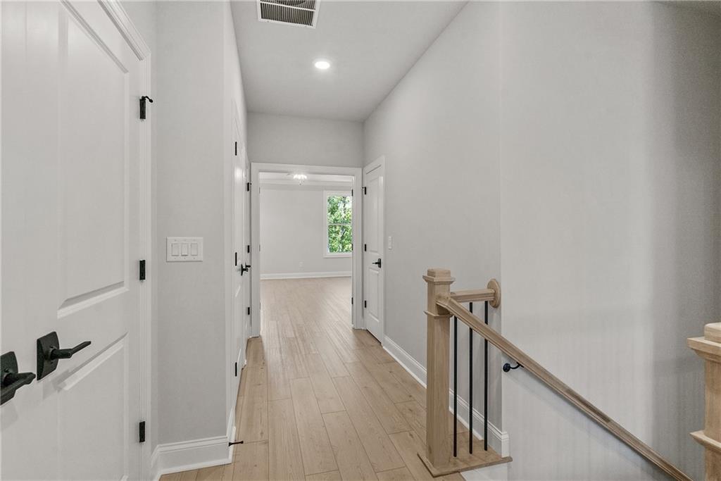 5715 Broad River View, Unit 449 Peachtree Corners, GA 30092 - Photo 19 of 29 a view of a hallway with wooden floor and staircase