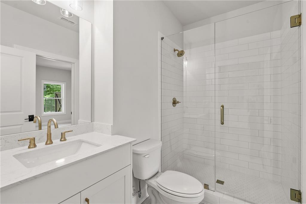 5715 Broad River View, Unit 449 Peachtree Corners, GA 30092 - Photo 20 of 29 a bathroom with a sink a toilet and shower