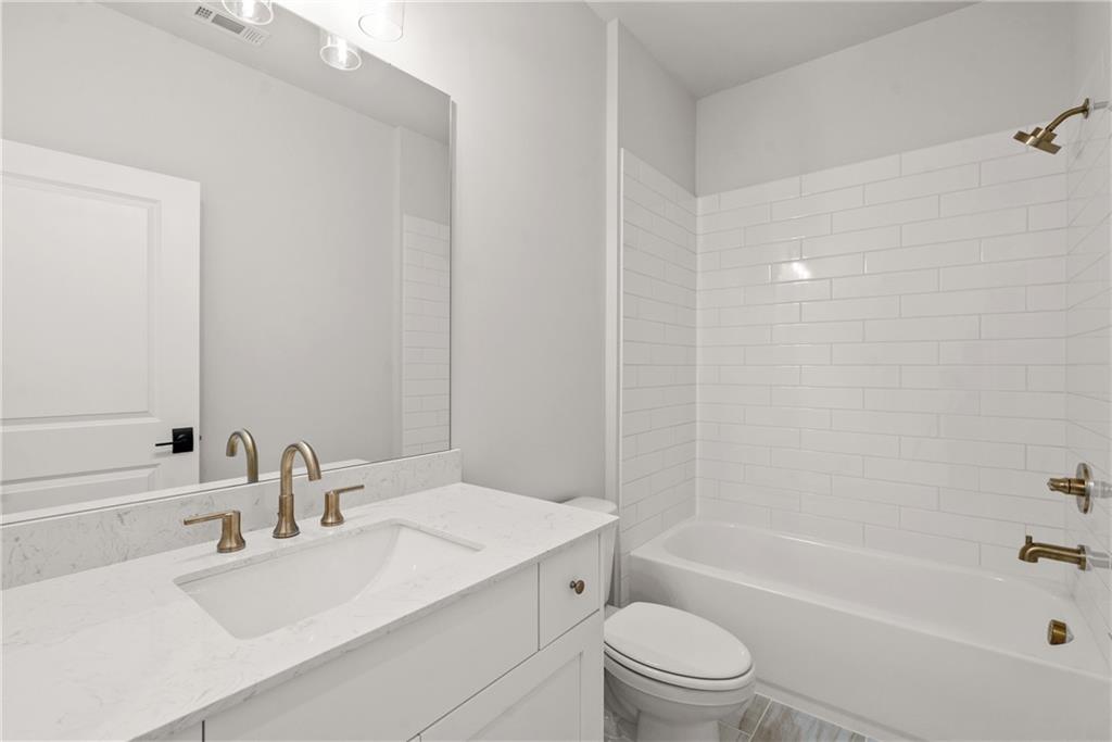 5715 Broad River View, Unit 449 Peachtree Corners, GA 30092 - Photo 21 of 29 a bathroom with a sink a toilet and a bathtub