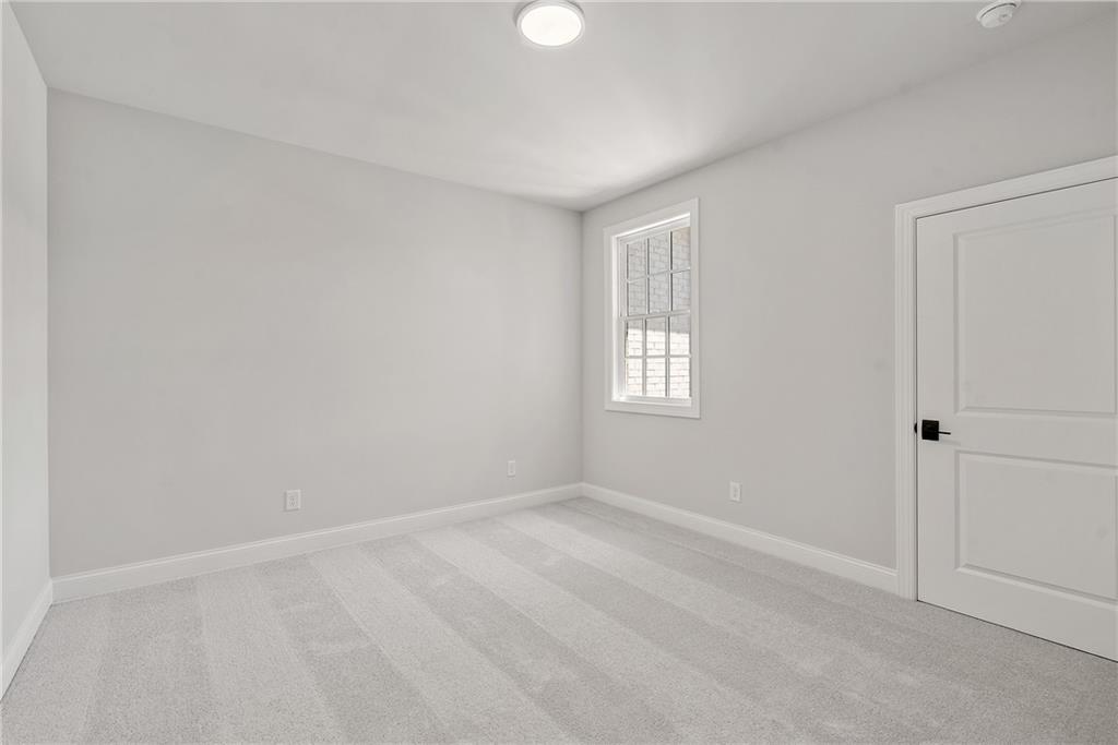 5715 Broad River View, Unit 449 Peachtree Corners, GA 30092 - Photo 23 of 29 a view of an empty room with a window and closet area