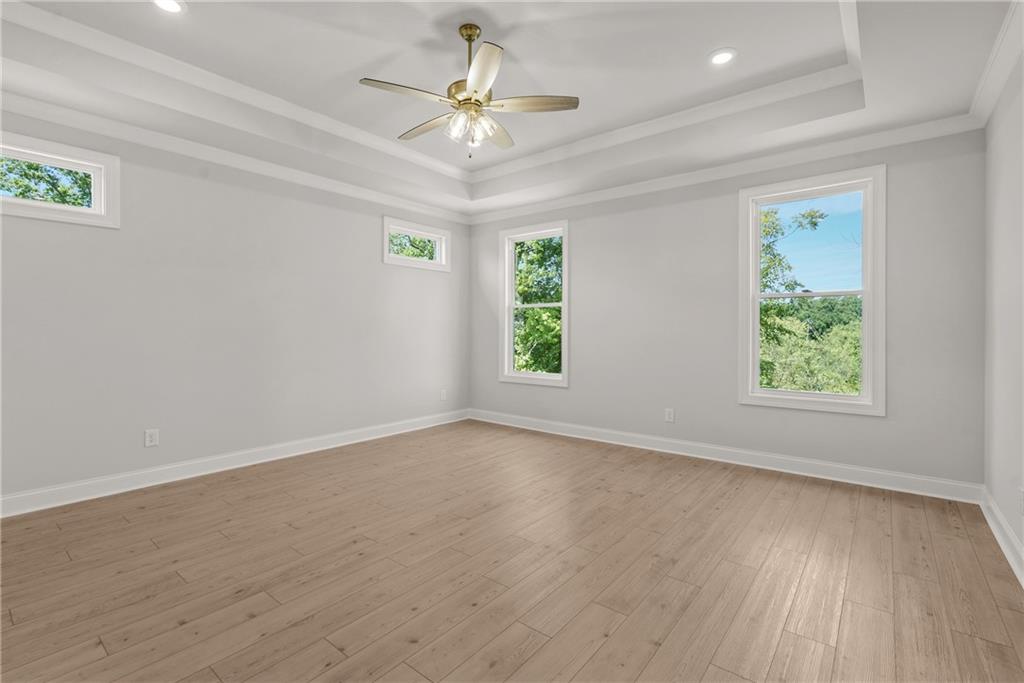 5715 Broad River View, Unit 449 Peachtree Corners, GA 30092 - Photo 28 of 29 wooden floor in an empty room with a window