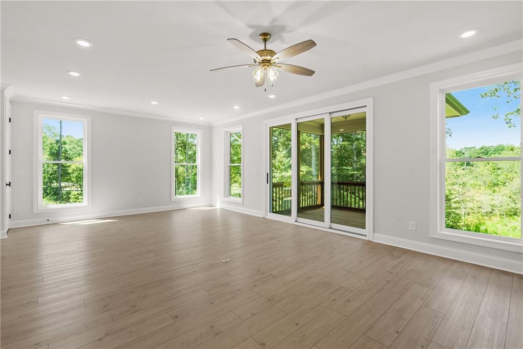 5715 Broad River View, Unit 449 Peachtree Corners, GA 30092 - Photo 6 of 29 a view of an empty room with wooden floor and a window