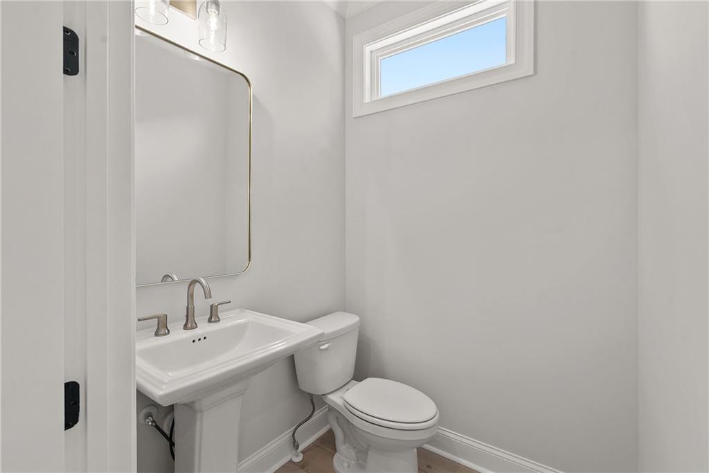 5715 Broad River View, Unit 449 Peachtree Corners, GA 30092 - Photo 7 of 29 a white toilet sitting next to a white sink