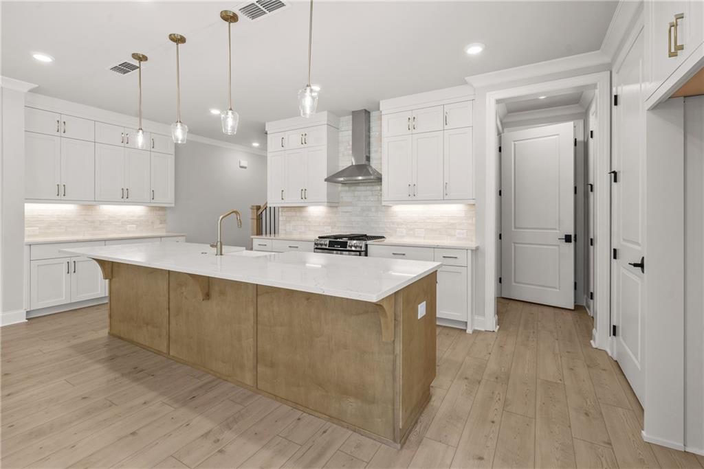 5715 Broad River View, Unit 449 Peachtree Corners, GA 30092 - Photo 8 of 29 a kitchen with kitchen island a sink stainless steel appliances and cabinets
