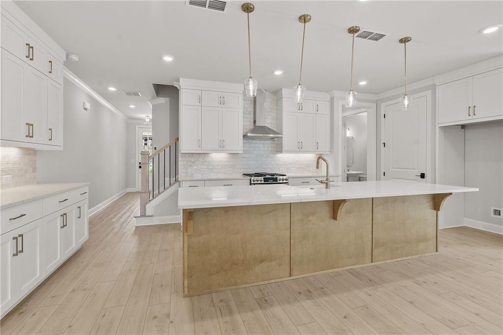 5715 Broad River View, Unit 449 Peachtree Corners, GA 30092 - Photo 10 of 29 a large kitchen with kitchen island a island a sink stainless steel appliances and cabinets