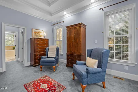 a living room with furniture a flat screen tv and a window