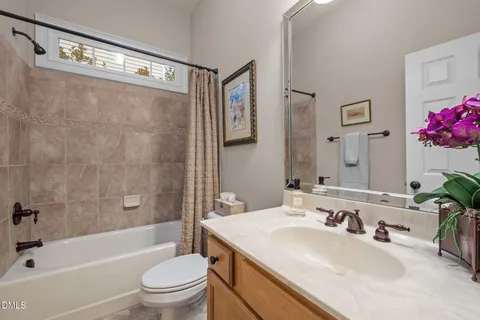 a bathroom with a sink mirror toilet and bathtub