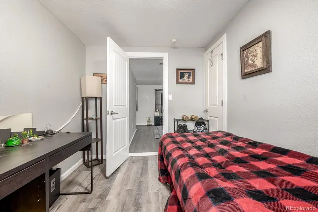 a bedroom with a bed and a desk