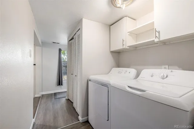 a view of washer and dryer with kitchen in the background