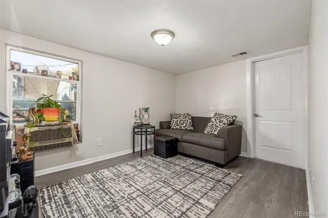 a living room with furniture and a rug