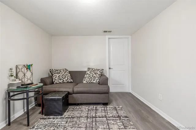 a living room with a couch and a rug
