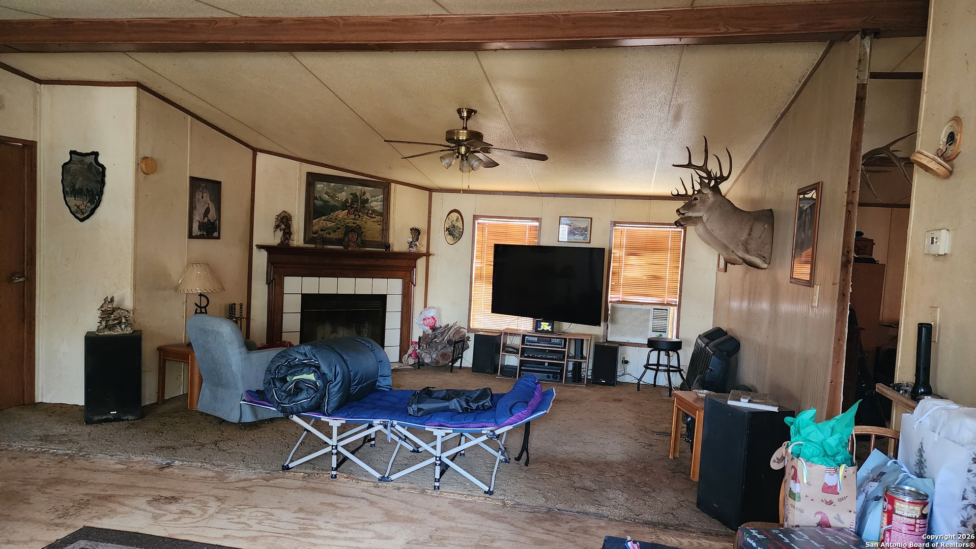 449 Hurst Lane Seguin, TX 78155 - Photo 20 of 28 a living room with furniture a flat screen tv and a fireplace