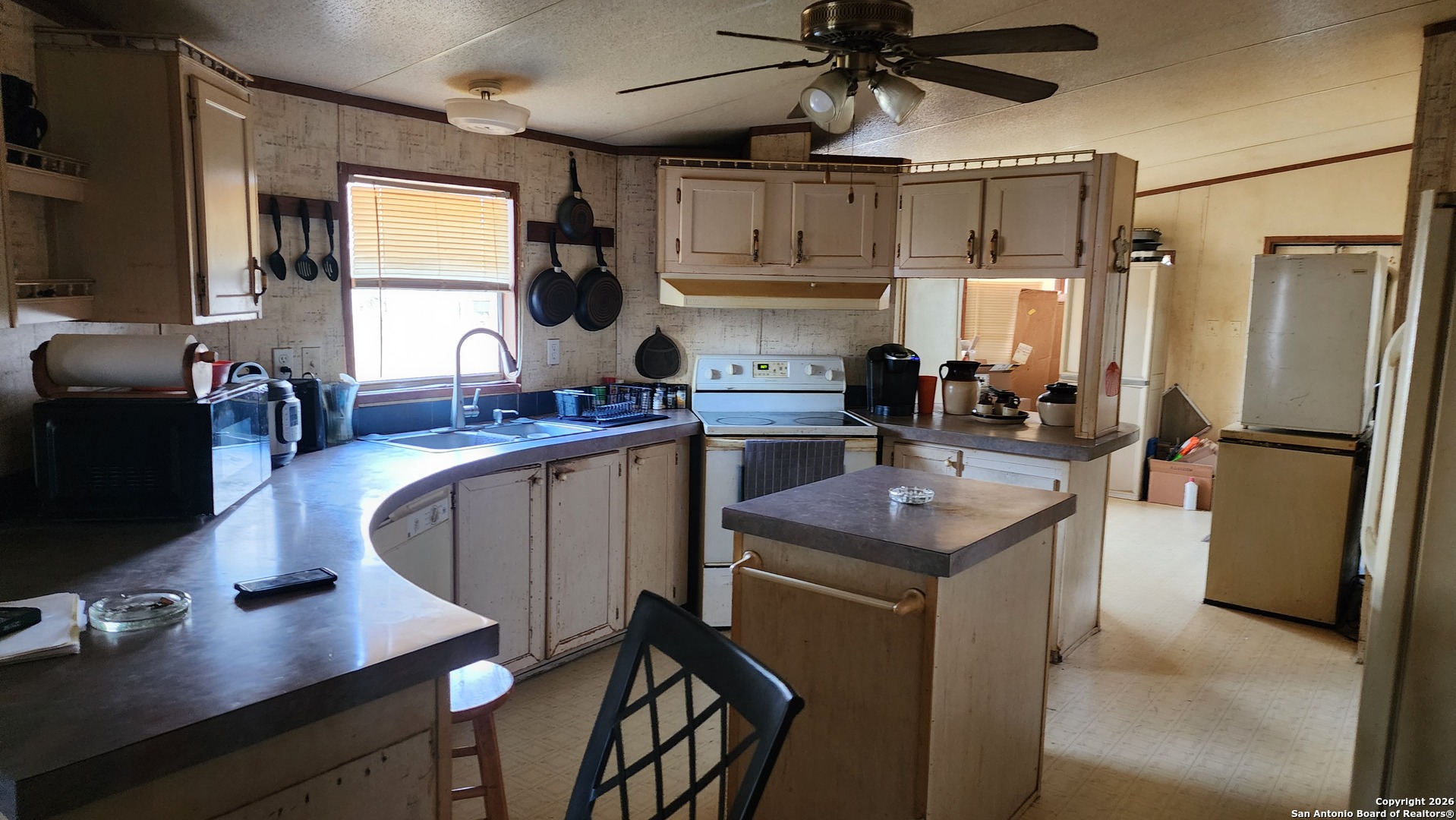 449 Hurst Lane Seguin, TX 78155 - Photo 24 of 28 a kitchen with stainless steel appliances granite countertop a sink refrigerator stove and microwave