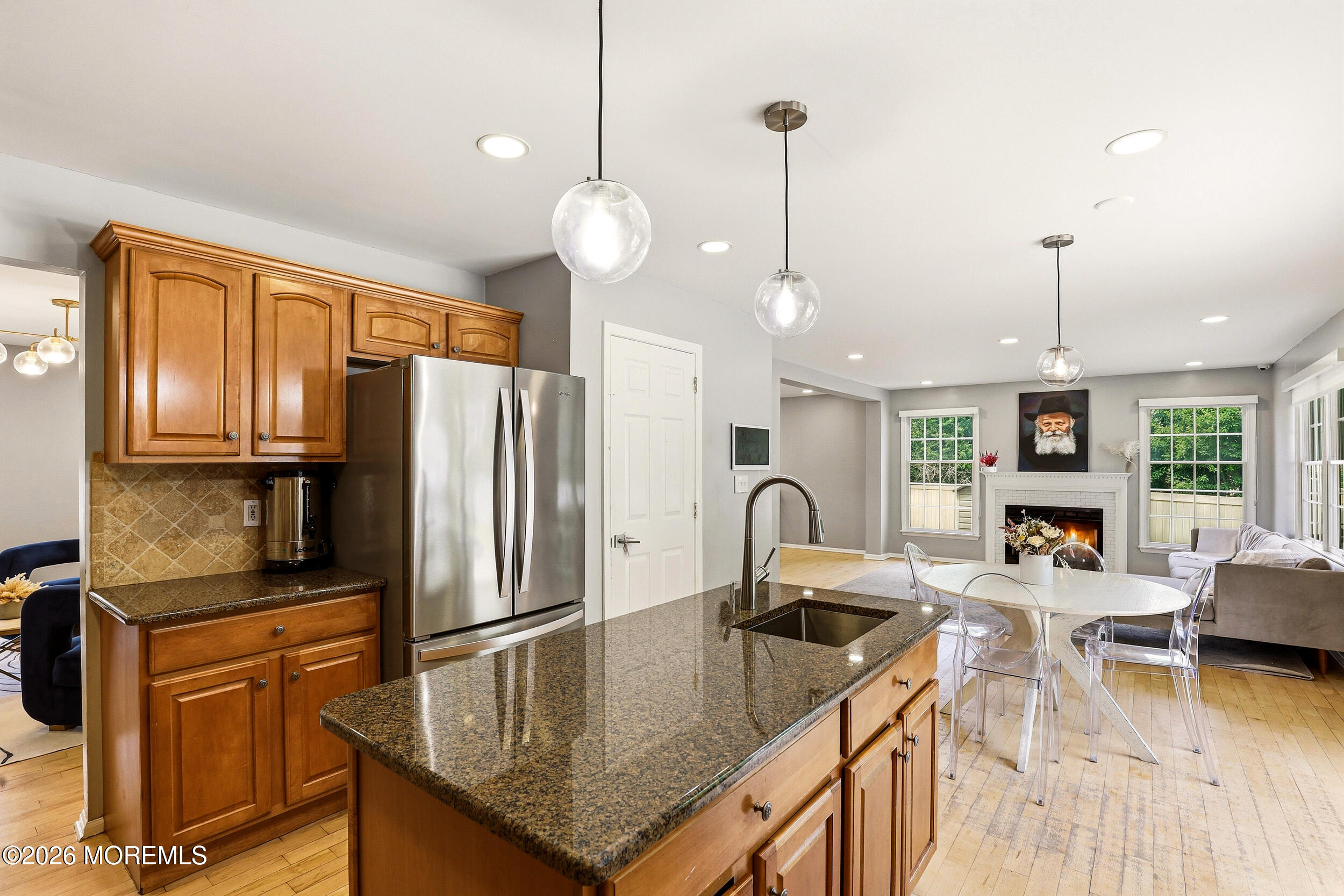 2055 MacKenzie Road Toms River, NJ 08755 - Photo 17 of 56 a kitchen with a refrigerator a stove a sink dishwasher a oven with a dining table and chairs with wooden floor