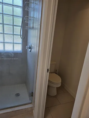 a bathroom with a toilet and shower