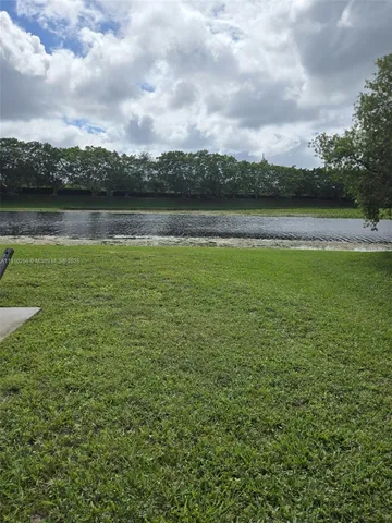a view of a lake with houses in the back