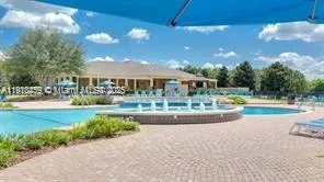 a view of swimming pool is middle in the garden