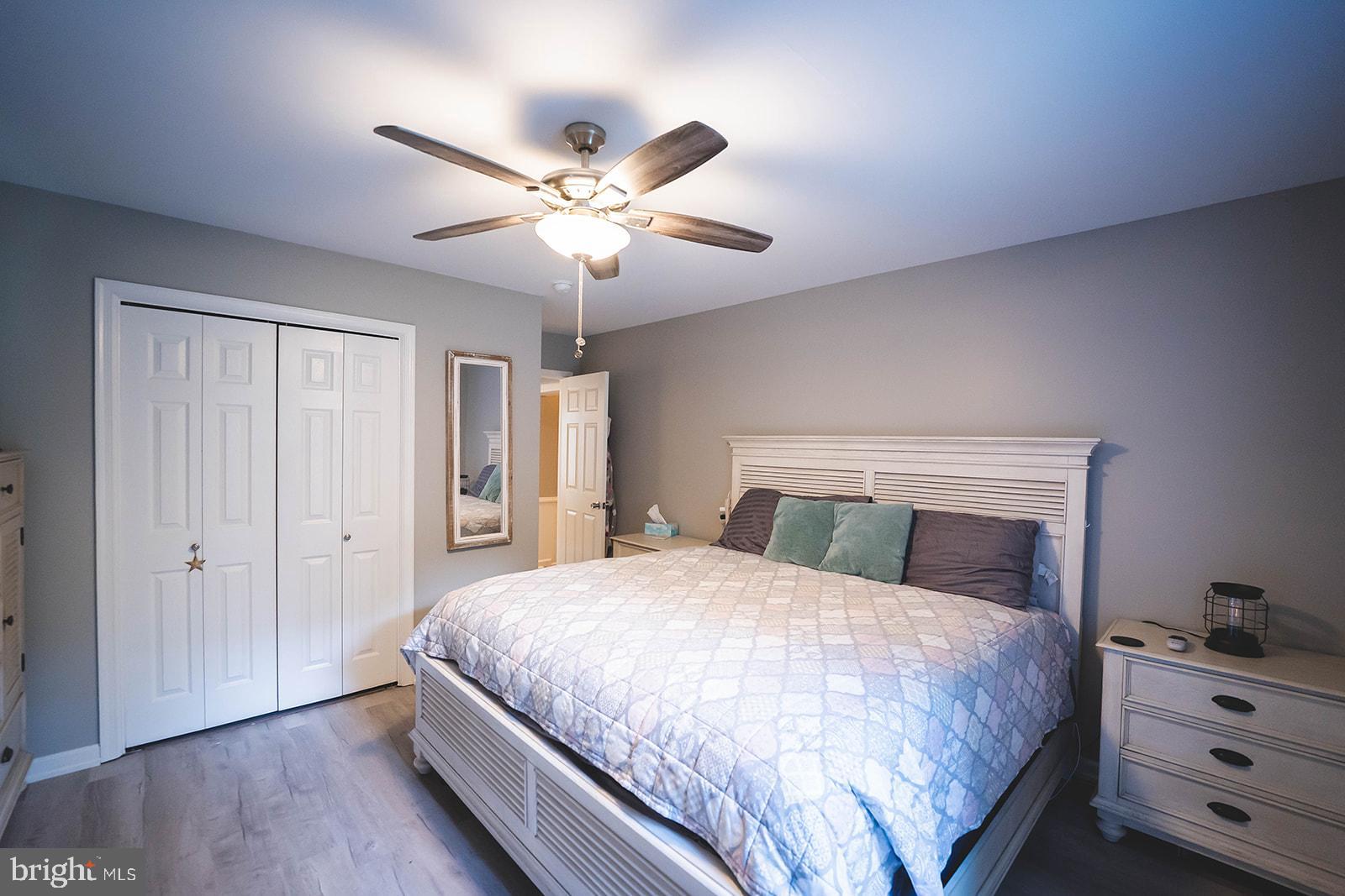 21831 Wetipquin Road Quantico, MD 21856 - Photo 37 of 57 a bedroom with a large bed and wooden floor
