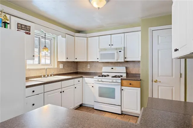 a white refrigerator freezer sitting inside of a kitchen
