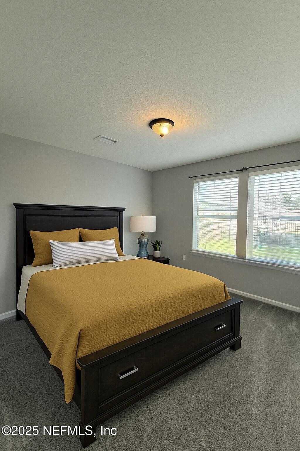 77041 Cobblestone Drive Yulee, FL 32097 - Photo 14 of 23 a bed sitting in a bedroom next to a window